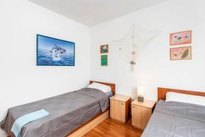 une chambre avec deux lits et un tableau au mur dans l'établissement Apartment Draga, à Vir