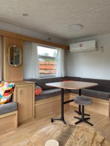 a dining area with a table in a caravan at Houseboatvinkeveen Lelie in Vinkeveen