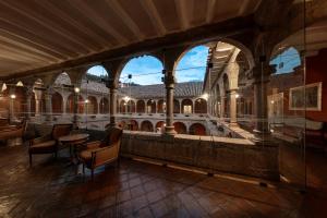 a large building with tables and chairs and a fountain at Wyndham Costa del Sol Cusco in Cusco