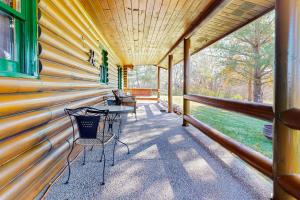 a porch of a house with a table and chairs at Hager Cabin AND Loft in Aledo