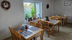 a dining room with wooden tables and chairs and a window at Noclegi u Przewodników - Zwiedzaczek in Lubawka +44 photos