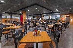 a dining room with wooden tables and chairs at Best Western Royal Plaza Hotel and Trade Center in Marlborough