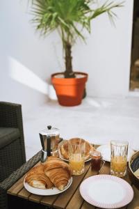 a table with a plate of bread and glasses on it at Da Mona in Reims
