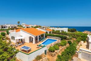 an aerial view of a house with a swimming pool at Villa Blanc Arenal by Villa Plus in Es Mercadal
