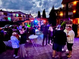 a crowd of people standing in a street at night at Dworek Karwia Wiosenna 8 in Karwia