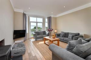 a living room with two couches and a television at 1 Coed y Llyn in Abersoch