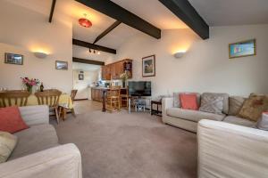 a living room with a couch and a dining room at Rose Cottage in Llanbedrog