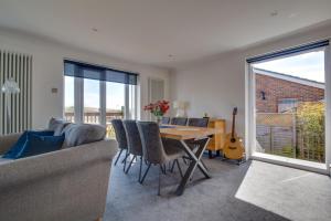 a living room with a table and a couch at Sandpipers in Rottingdean