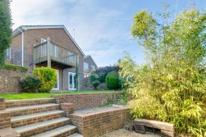 a brick house with stairs in front of it at Sandpipers in Rottingdean