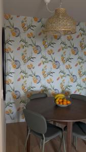 a table with a bowl of fruit on a wall at Mira Serra Hostel in Caria +26 photos