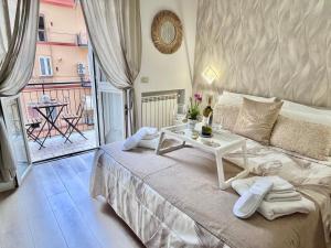 a bedroom with a white bed with a table on it at Mazzocchi House welcome wine in Naples