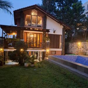 a house with a swimming pool at night at Villa Elisabeth at Villa Istana Bunga in Bandung