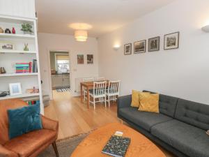 a living room with a couch and a table at Potters Cottage in Sheffield