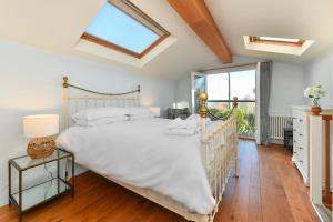 a bedroom with a large bed and a window at Pengarth Cottage in Abersoch