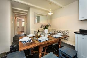 a dining room with a wooden table and chairs at Pengarth Cottage in Abersoch