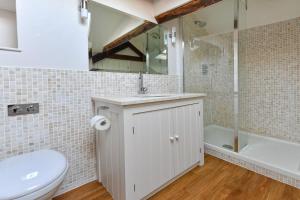 a bathroom with a toilet and a sink and a tub at Pengarth Cottage in Abersoch +17 photos
