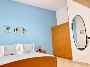 a bedroom with a large bed and a mirror at Deborah's House in Ercolano