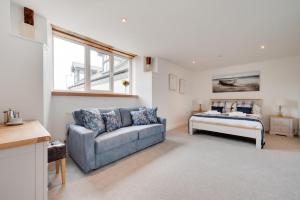 a living room with a couch and a table at Neptune in Saundersfoot