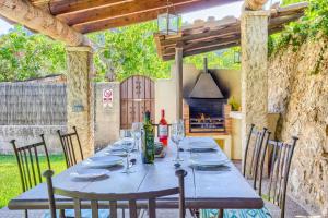 a table with wine bottles and glasses on a patio at Villa Rafaleta by Villa Plus in Pollença