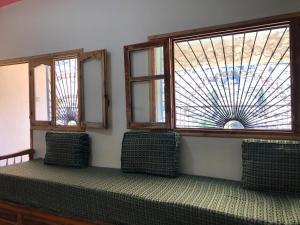 a room with two chairs and a window at Room with amazing view on mountain Tidghine Ketama in Ketama +1 photo