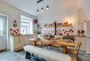 a kitchen with a wooden table and chairs at 1 Rose Cottage in Hawes