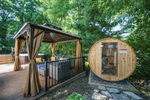 a large wooden building with a gazebo on a deck at The Newly Built Custom Townhome by Granger Gardens in Ann Arbor