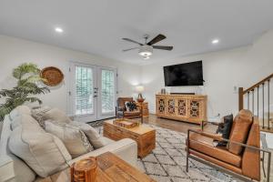 a living room filled with furniture and a flat screen tv at The Newly Built Custom Townhome by Granger Gardens in Ann Arbor