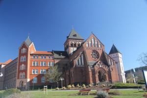 a large brick building with a clock tower at Ferienwohnung Missionshausstrasse in Sankt Wendel