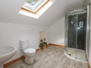 a bathroom with a toilet and a glass shower at Old Forge Apartment in Wolverley +17 photos