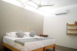 a bedroom with a bed in a room at Casa Macuil in Brisas de Zicatela