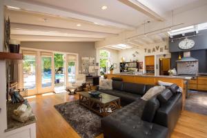 a living room with a couch and a kitchen at Wine Country Retreat Zinfandel Lane Villa in St. Helena