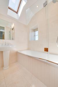a white bathroom with a sink and a shower at Kemyel Mill in Paul