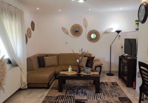 a living room with a couch and a coffee table at Oasis Cottage in Krepeni