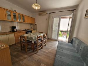 a kitchen with a table and chairs and a dining room at Apartment Savar 8079c in Brbinj