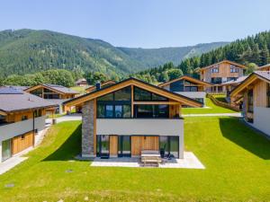 an aerial view of a house with mountains in the background at Grebenzen Lodge Prinz in Sankt Lambrecht