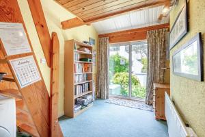 a room with a book shelf and a window at Llwyn y Morfa in Morfa Nefyn