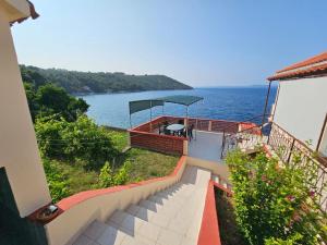 a balcony of a house with a view of the water at Apartments by the sea Savar, Dugi otok - 8079 in Brbinj