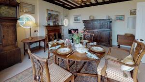 a dining room with a wooden table and chairs at Trefaes in Abersoch