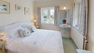 a bedroom with a bed and a sink and a window at Trefaes in Abersoch