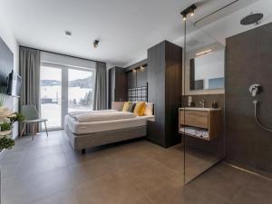 a bedroom with a bed and a glass shower at Alpenchalet Lambert in Sankt Lambrecht +64 photos