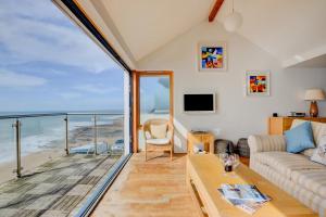 a living room with a view of the ocean at Ocean Blue in Porthleven
