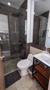 a bathroom with a toilet and a shower and a sink at Vita905 RODADERO in Santa Marta +7 photos