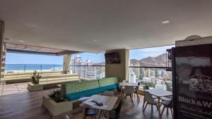 a living room with a couch and tables and a view at Vita905 RODADERO in Santa Marta
