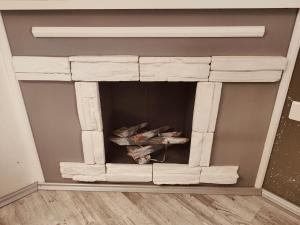 a fireplace is made out ofrified wood at BL App in Antunovac