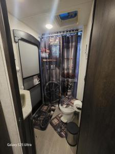 a small bathroom with a toilet and a shower at Rv Getaway in Lakeland +15 photos
