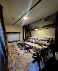 a bedroom with a large bed with a wooden headboard at Rv Getaway in Lakeland +15 photos