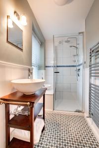 a bathroom with a sink and a shower at Hillside in Croyde +35 photos