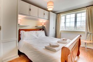 a bedroom with a bed with towels on it at Cherry Garth in Sleights