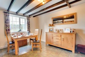 a dining room with a table and a window at Cherry Garth in Sleights