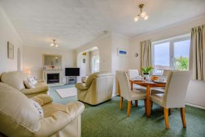 a living room with a table and chairs at 3 Bed in Padstow oc-p00131 in Saint Merryn